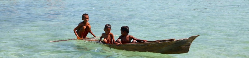 Boys from an indigenous Bajau Laut community travel in a dugout on the waters off the eastern coast of the town of Semporna in Sabah State in East Malaysia, on the island of Borneo. 
